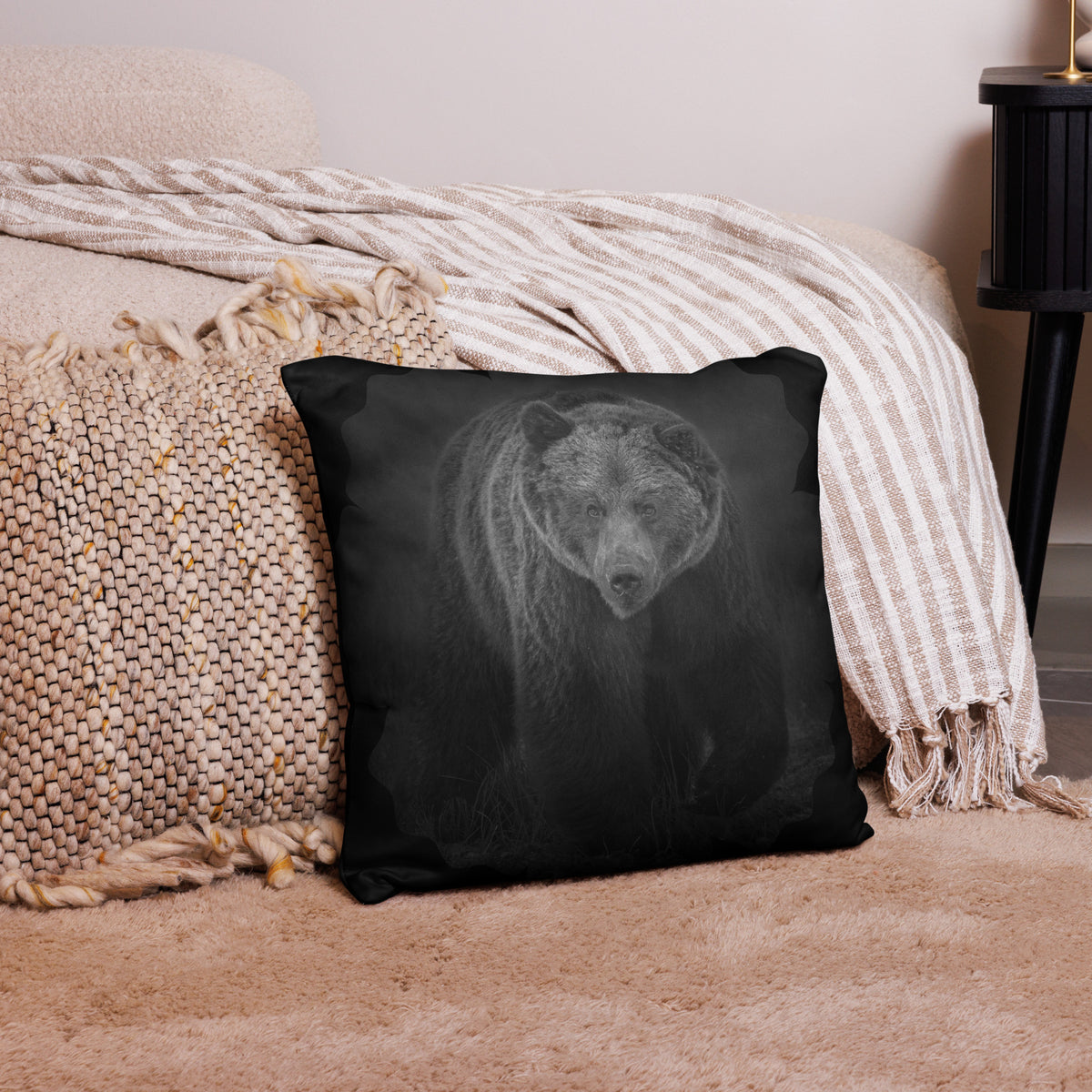 Double-sided dark bear print throw pillow on a cozy couch, bringing Scandinavian wilderness to interior design.