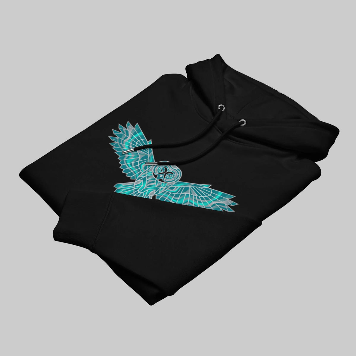 Folded black premium eco hoodie by Novapuro displaying the vibrant geometric teal owl chest print.