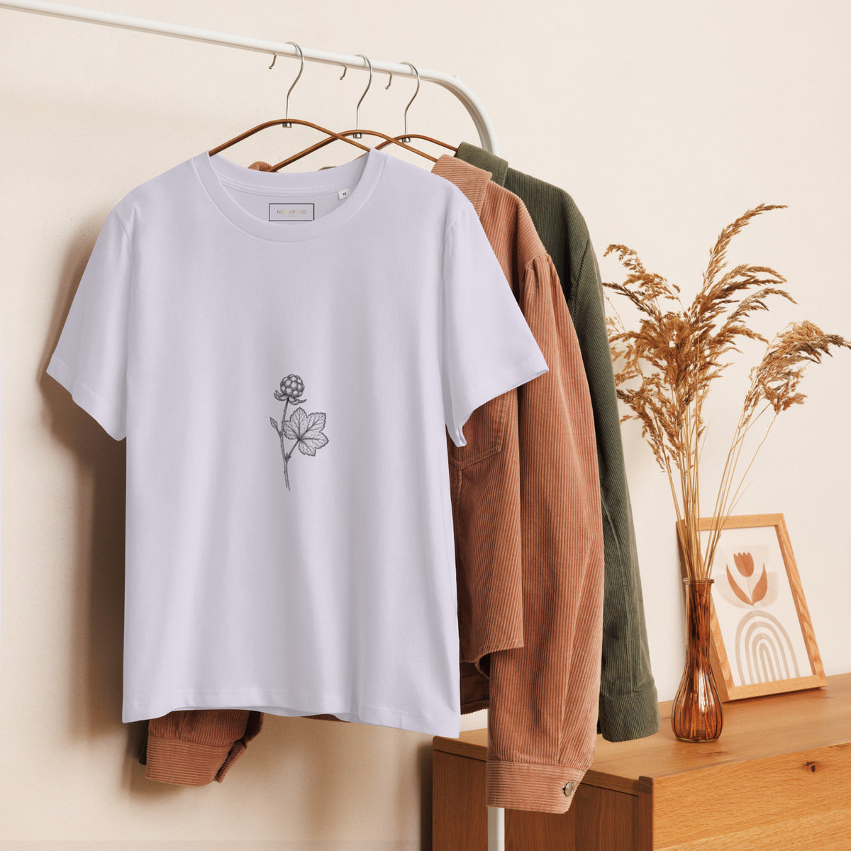 Lifestyle shot of a woman wearing the Novapuro Cloudberry women's eco tee in a natural setting.