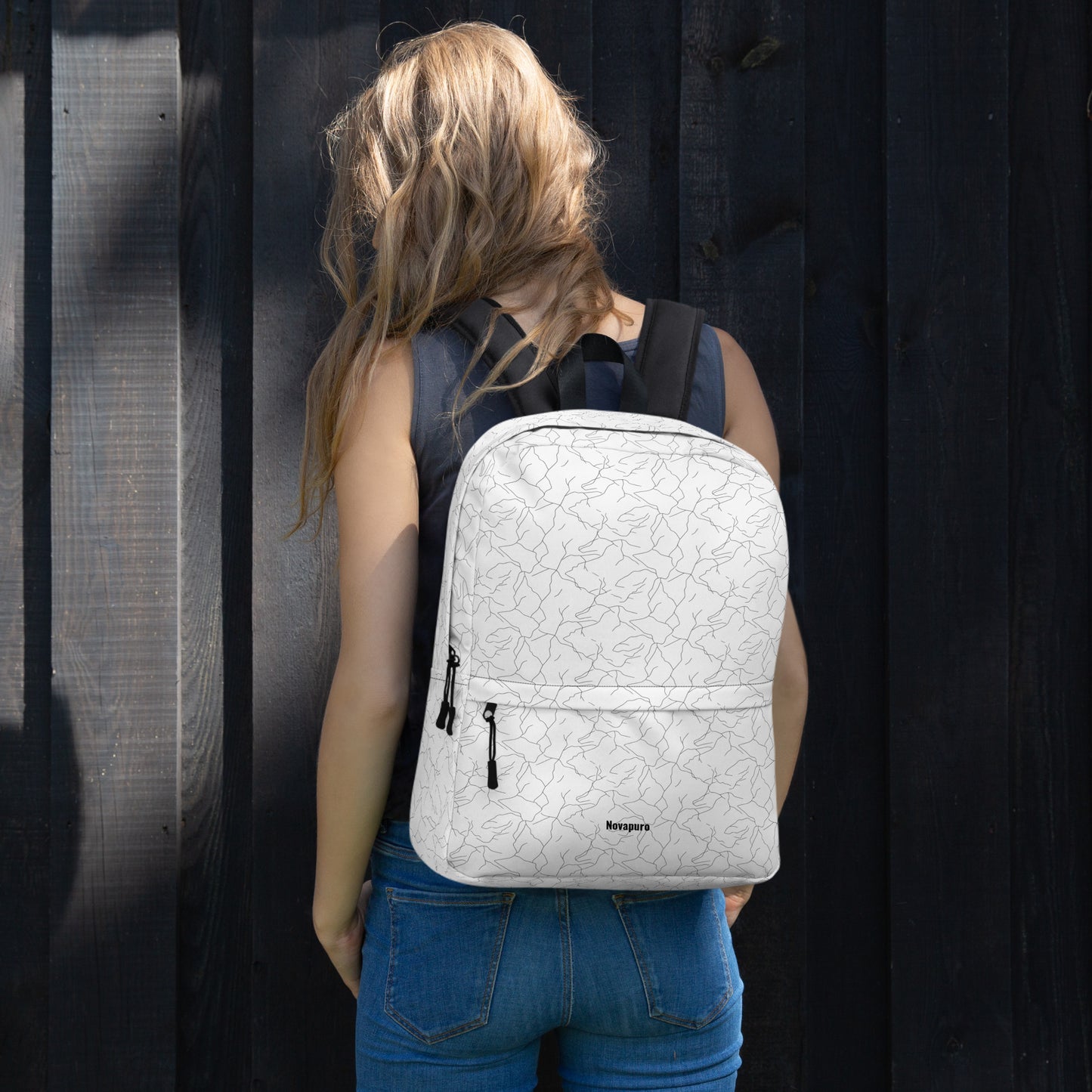 Minimalist white everyday backpack with a seamless black abstract pattern resembling cracking spring ice by Novapuro