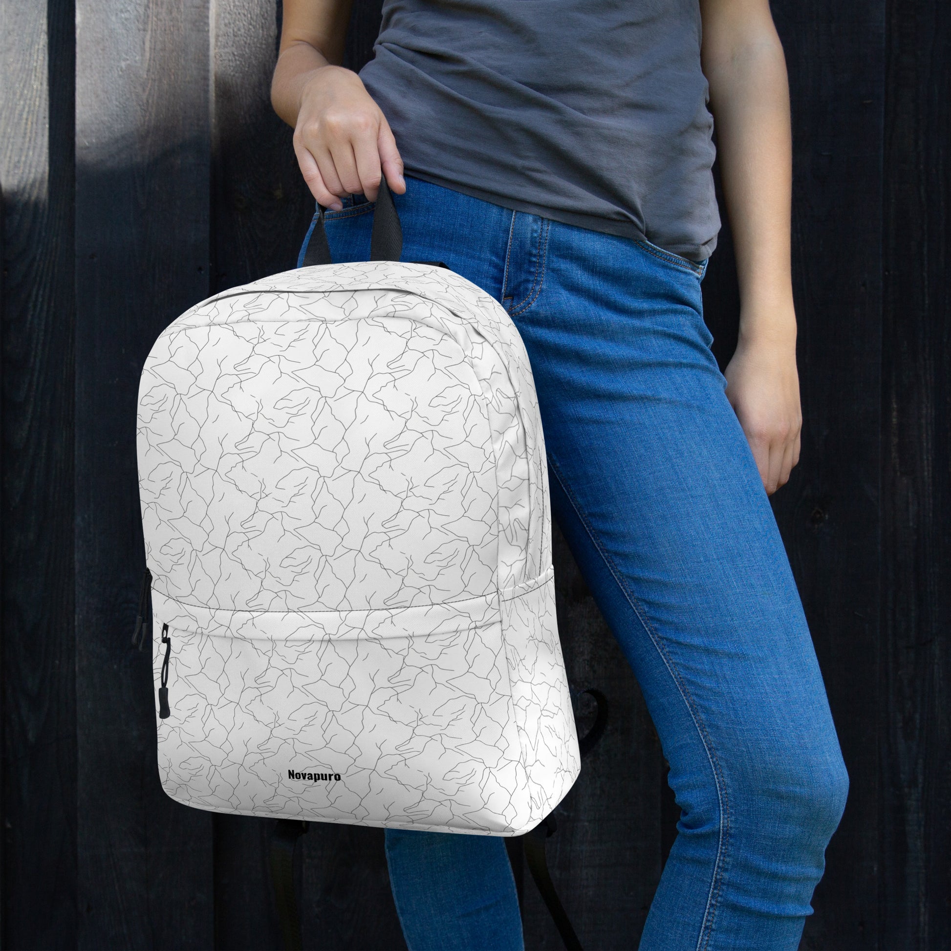 Minimalist white everyday backpack with a seamless black abstract pattern resembling cracking spring ice by Novapuro