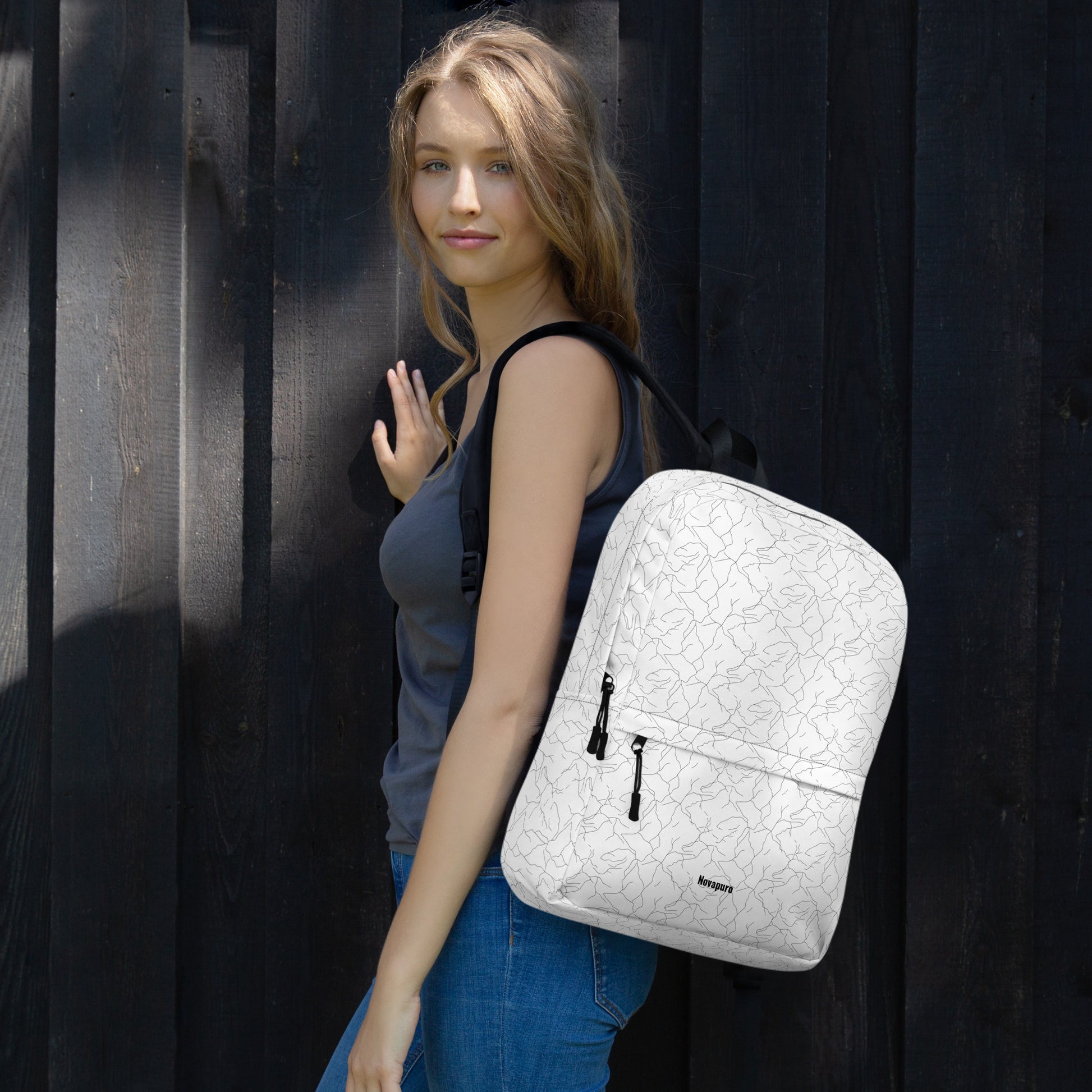 Minimalist white everyday backpack with a seamless black abstract pattern resembling cracking spring ice by Novapuro