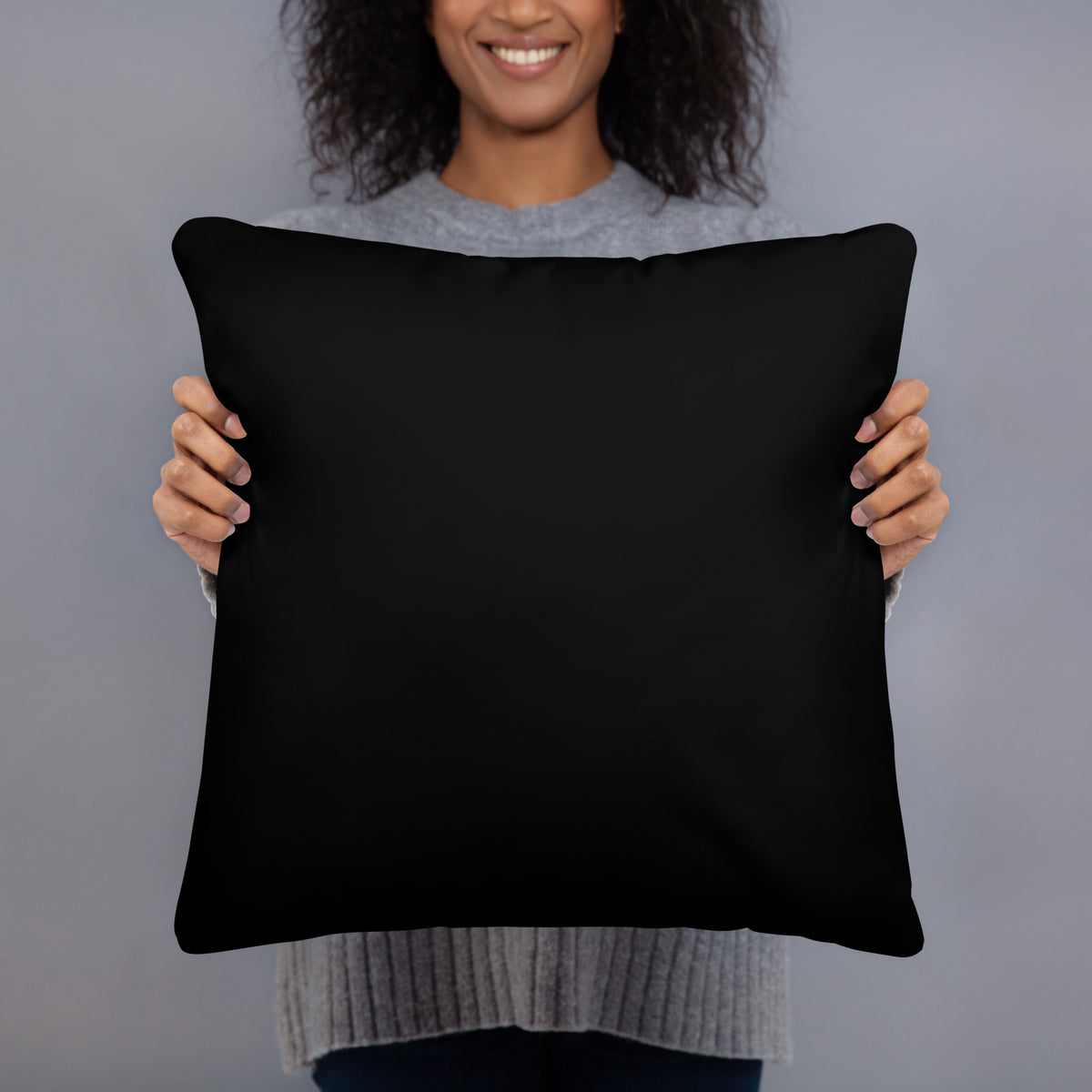 A black accent throw pillow featuring a Nordic long-eared owl chick print by Jarno Virtanen, resting on a bed.