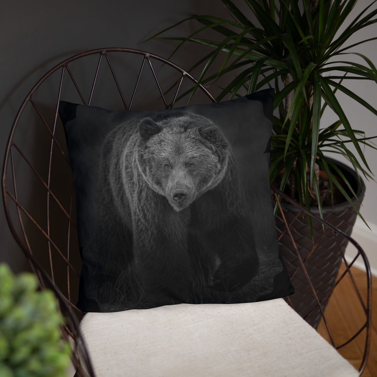 Dark decorative throw pillow featuring a moody brown bear photograph on a modern chair, Nordic home decor.