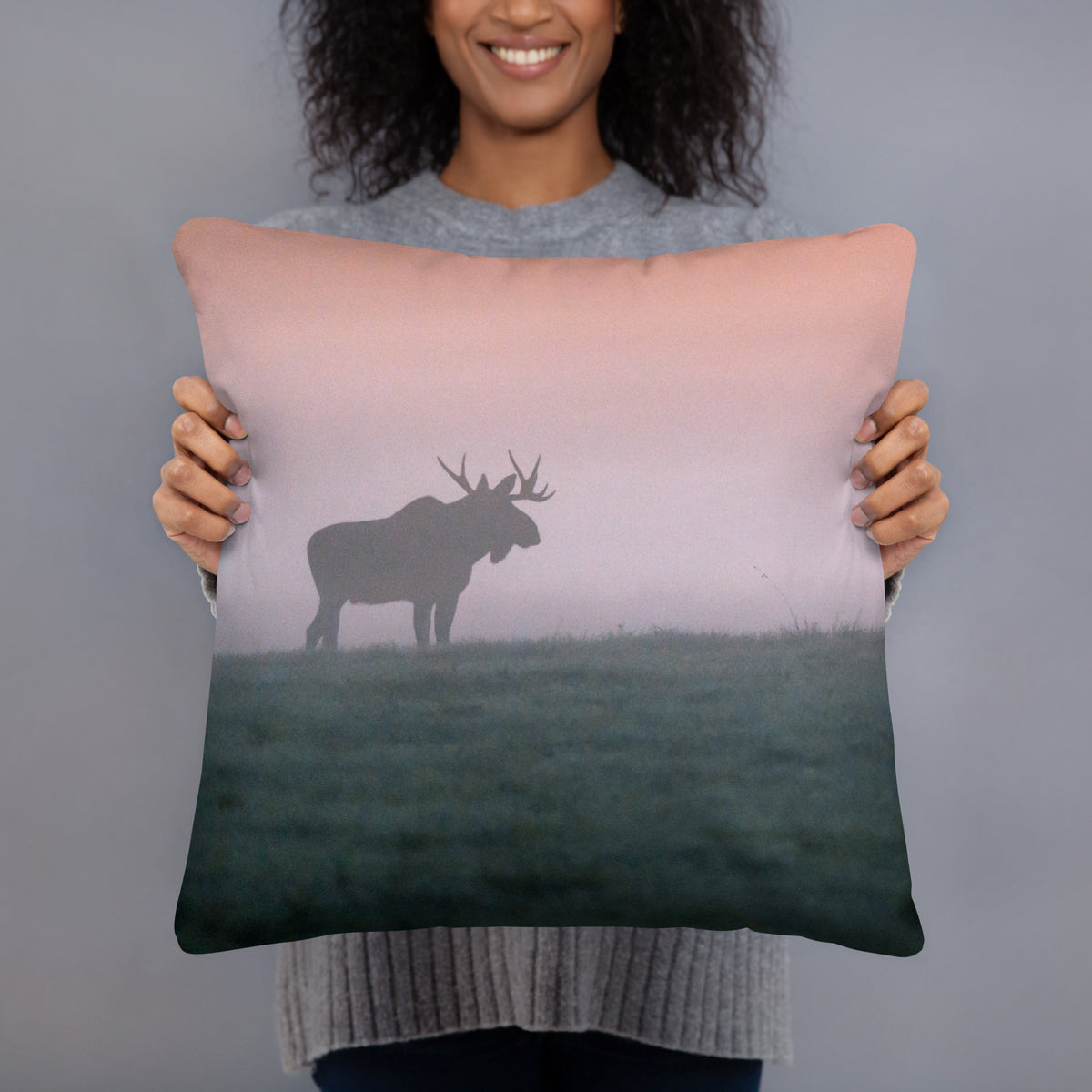 A person holding the soft 'Forest King' throw pillow, showcasing the artistic wildlife art and premium fabric.