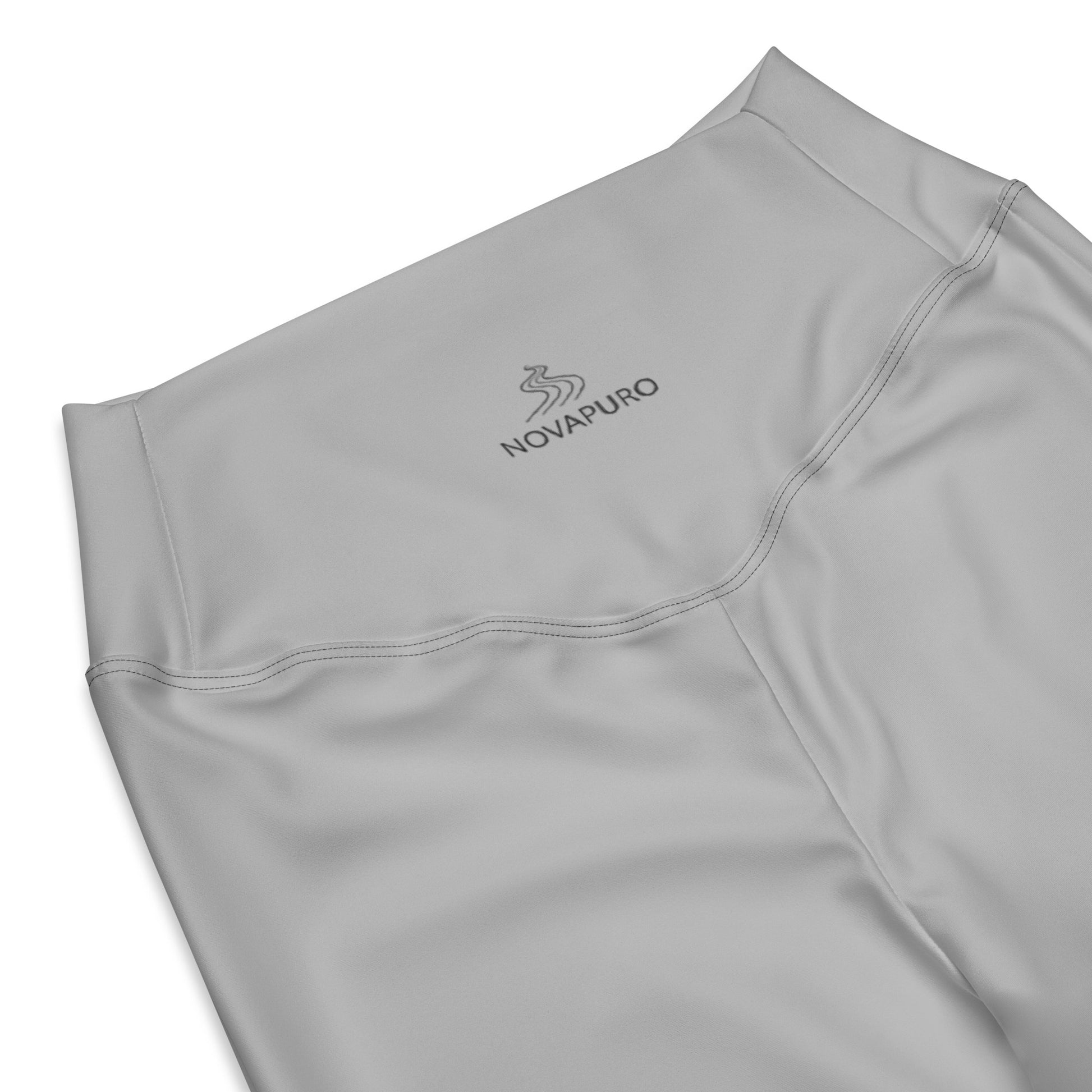 Close-up of the minimalist Novapuro logo on grey recycled flare leggings