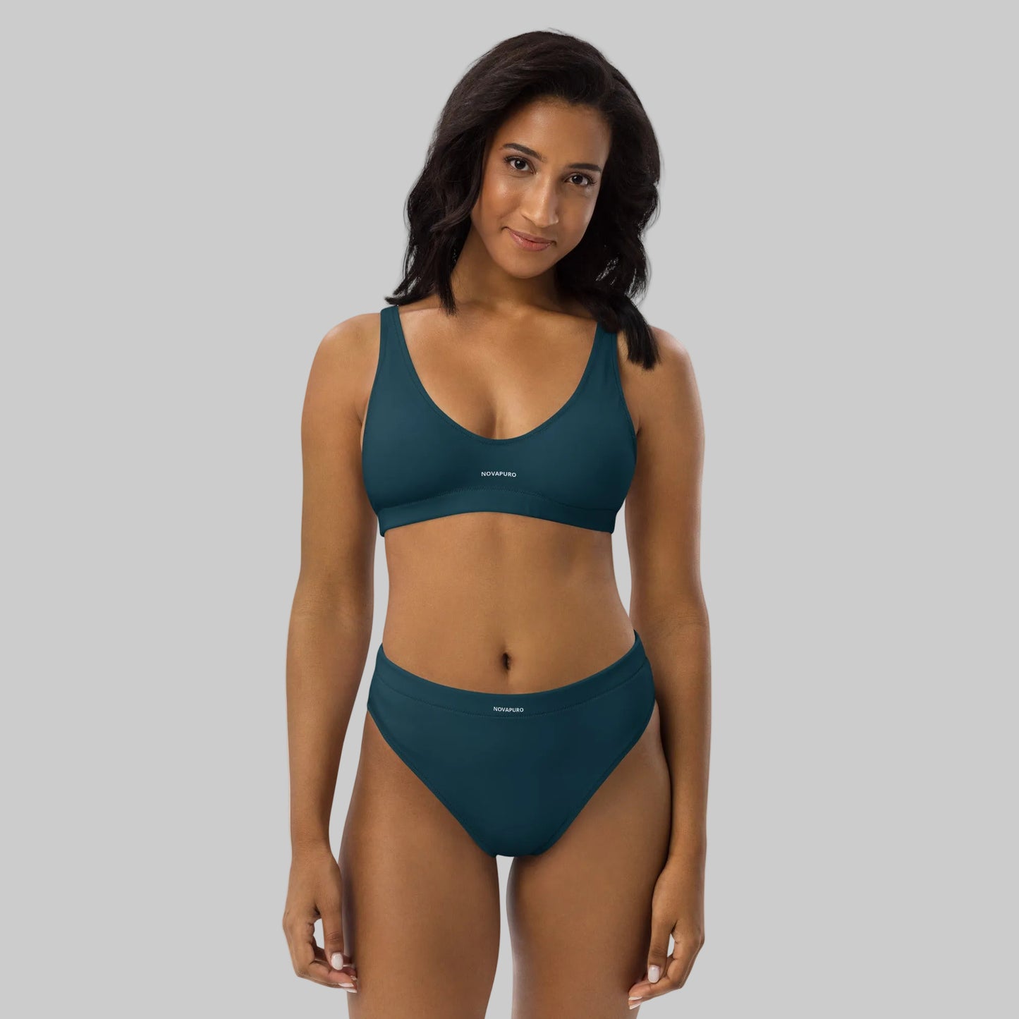 Model wearing dark blue Novapuro Signature recycled bikini set