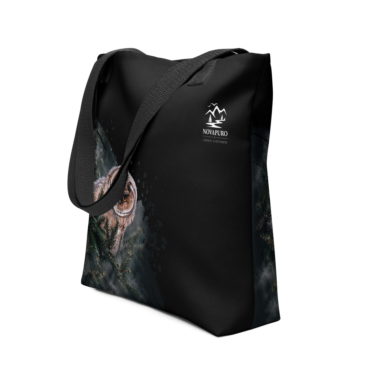 A person carrying the black Novapuro x Jarno Virtanen tote bag featuring a Nordic long-eared owl chick print on the lower side.