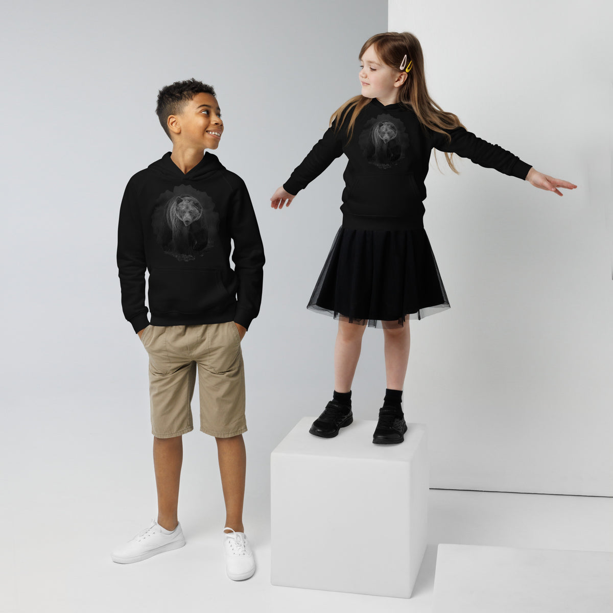 Black kids eco hoodie featuring a Nordic bear design, a sustainable nature-inspired collaboration between Novapuro and Auli Leivonen.
