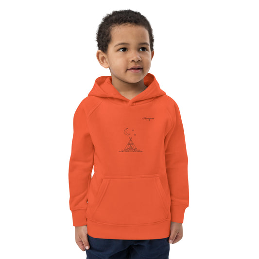Young boy wearing a burnt orange organic cotton kids hoodie featuring a minimalist black line art of a tiny tent and stars.