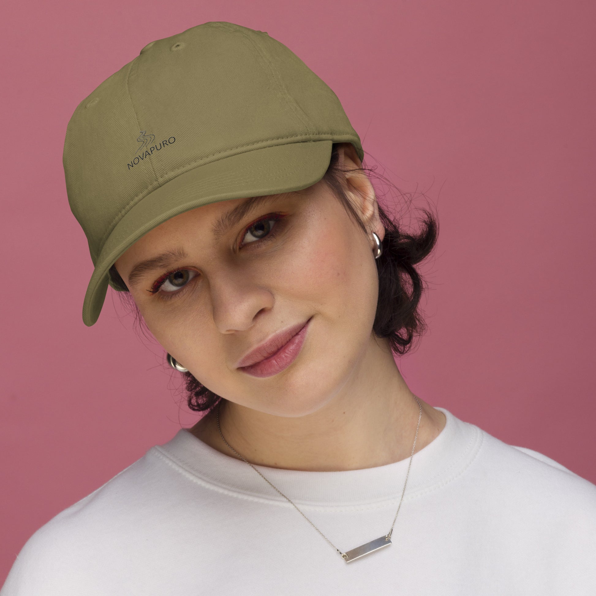 Model wearing the forest green Novapuro Signature Organic Cap made from sustainable cotton