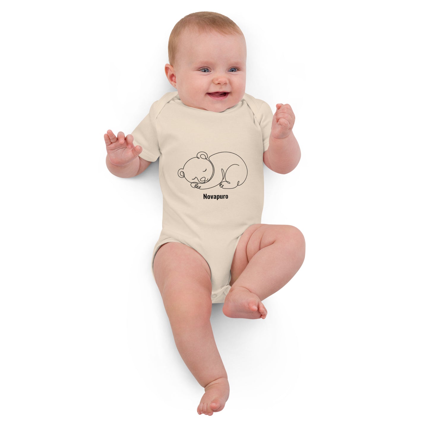 Baby wearing a sand-colored organic cotton bodysuit featuring a minimalist continuous line art of a sleeping bear and the Novapuro logo.