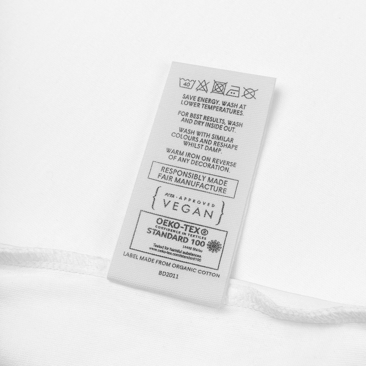 Close-up view of the organic cotton baby bodysuit showcasing the envelope neckline and soft fabric.
