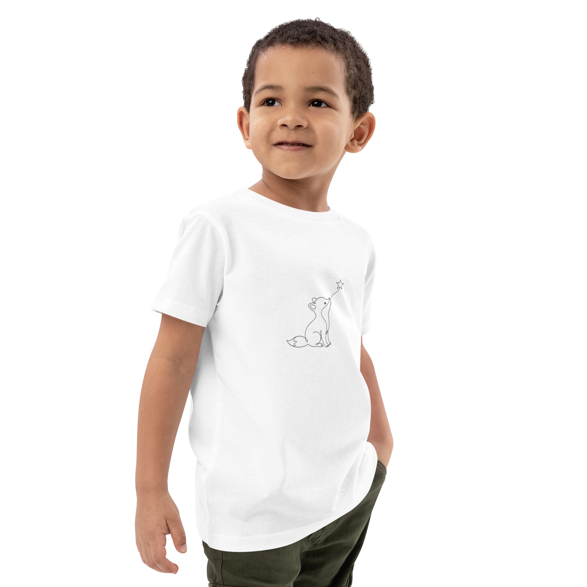 White organic cotton kids t-shirt worn by a young boy, featuring a minimalist black continuous line art of a small fox looking up at a star.