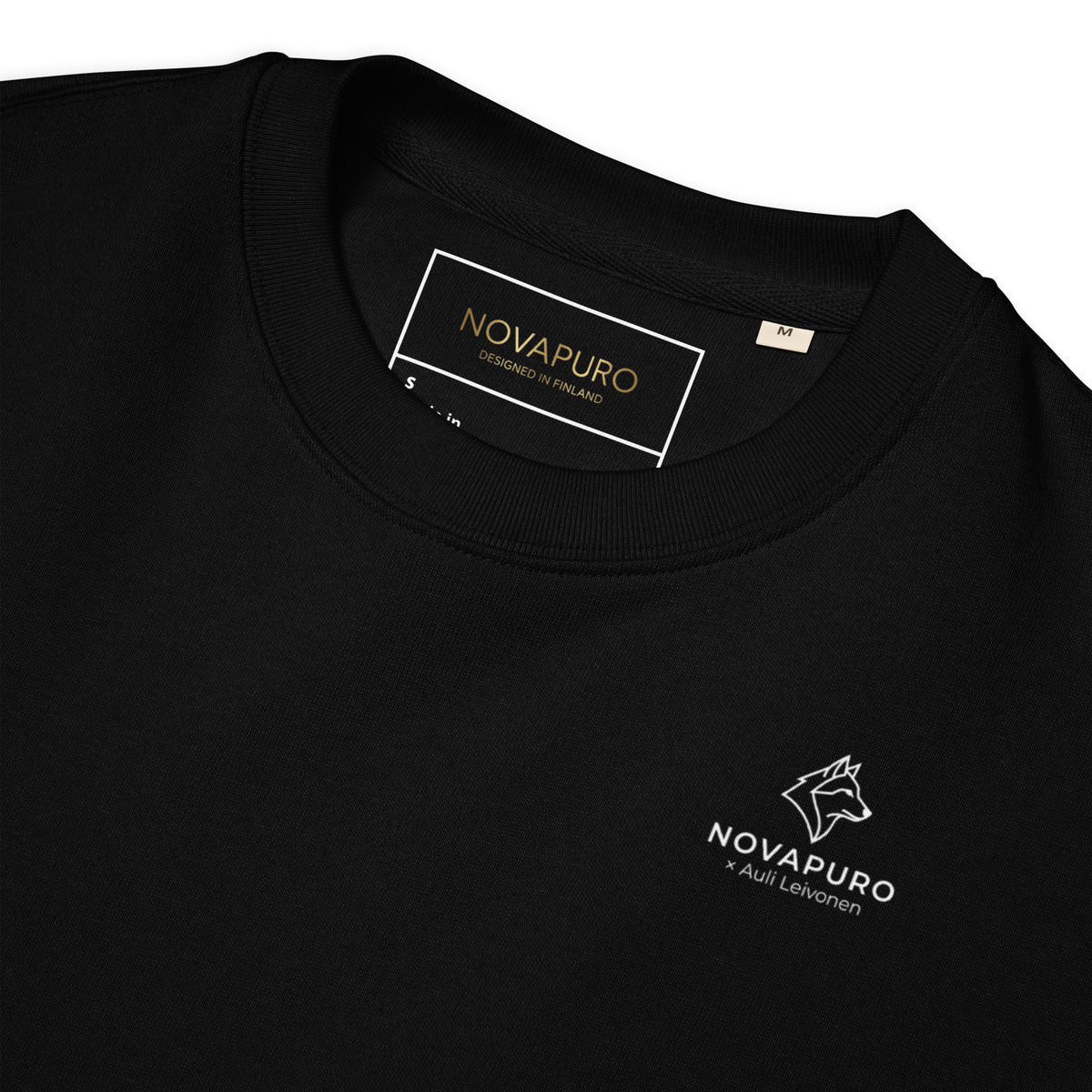 Folded black unisex organic cotton sweatshirt. High-quality sustainable fashion celebrating the untamed spirit of the northern wilderness.