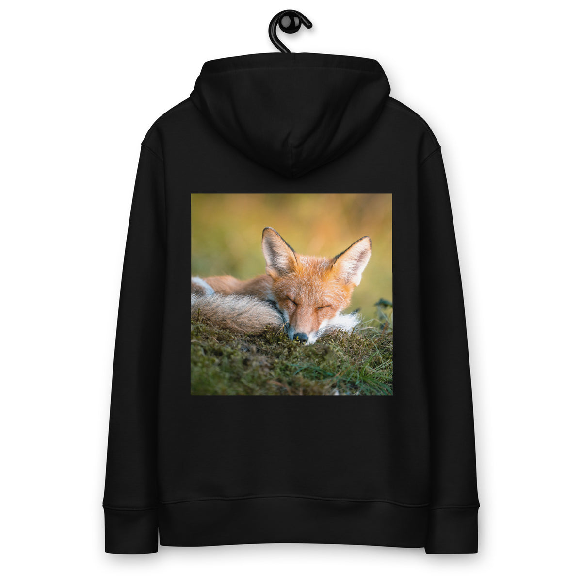 A person wearing a black heavyweight organic cotton hoodie seen from the back, featuring a captivating photograph of a resting red fox in the morning sun by Mikko Monto
