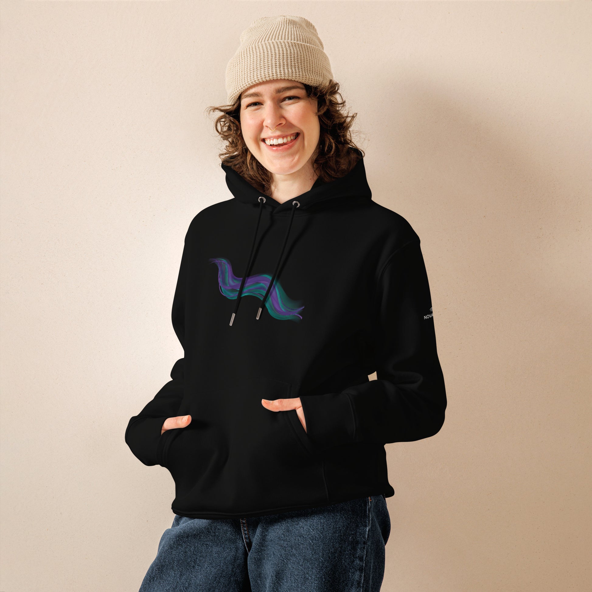 Model wearing the black Novapuro premium organic cotton hoodie featuring an abstract teal and violet aurora borealis design.