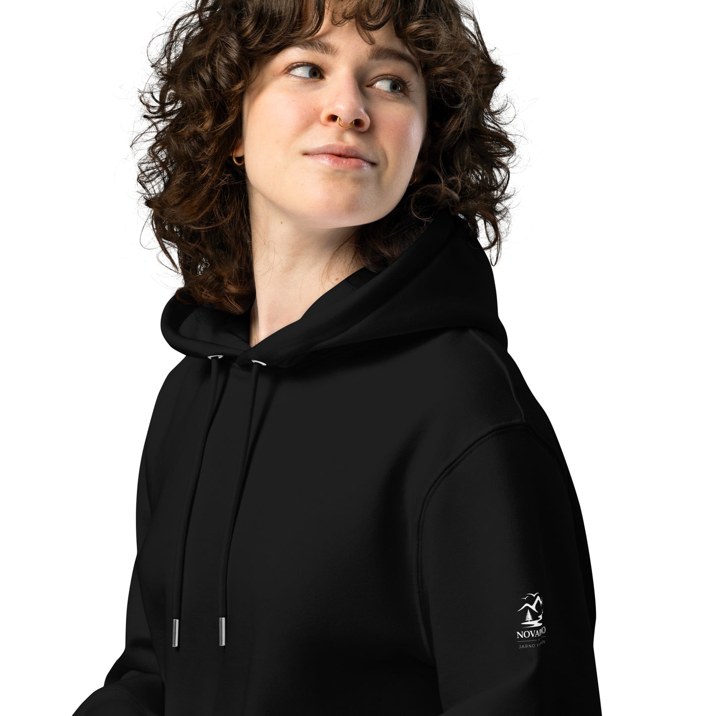Woman wearing a warm black organic cotton hoodie from the Novapuro x Jarno Virtanen collection. A versatile and comfortable choice for sustainable Nordic fashion.