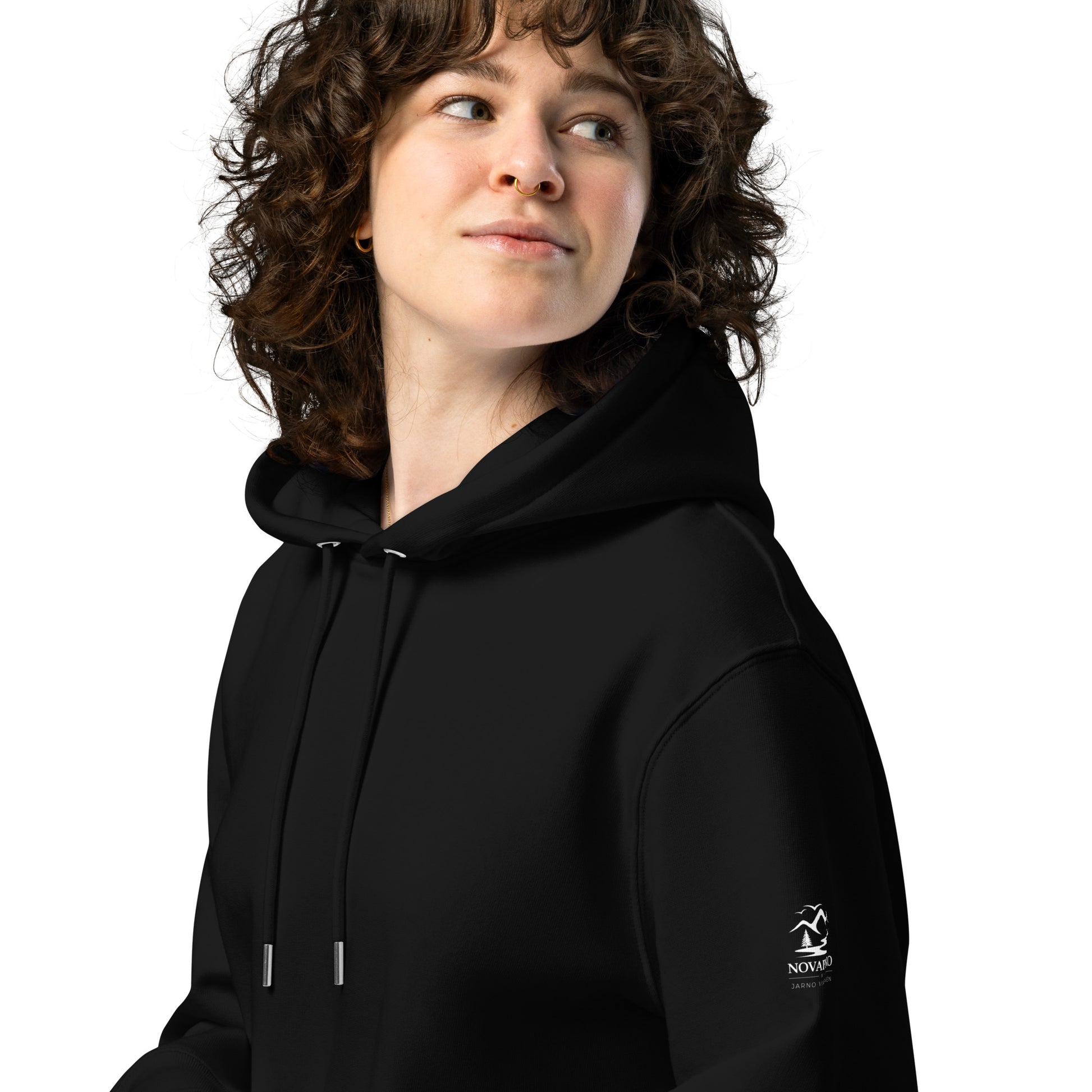 Woman wearing a warm black organic cotton hoodie from the Novapuro x Jarno Virtanen collection. A versatile and comfortable choice for sustainable Nordic fashion.