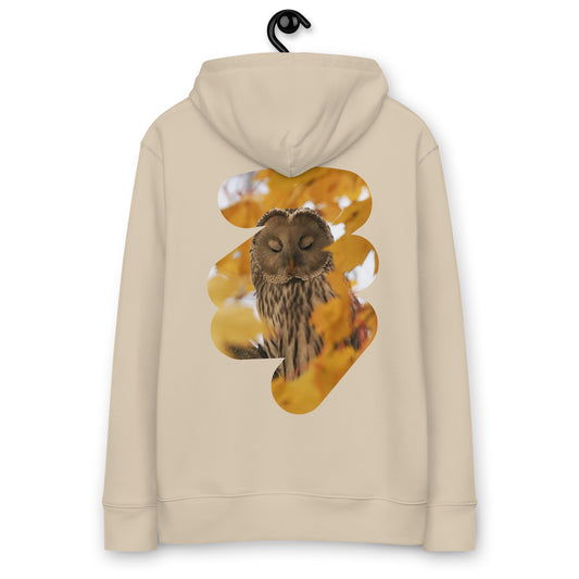 Eco-conscious woman wearing the Ural Owl Organic Eco Hoodie in the Nordic wilderness, showcasing fine art nature photography on the back.