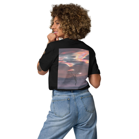 Back view of a female model wearing the black Jetro Luhtaa x Novapuro organic cotton t-shirt featuring a vibrant nacreous clouds photography print.