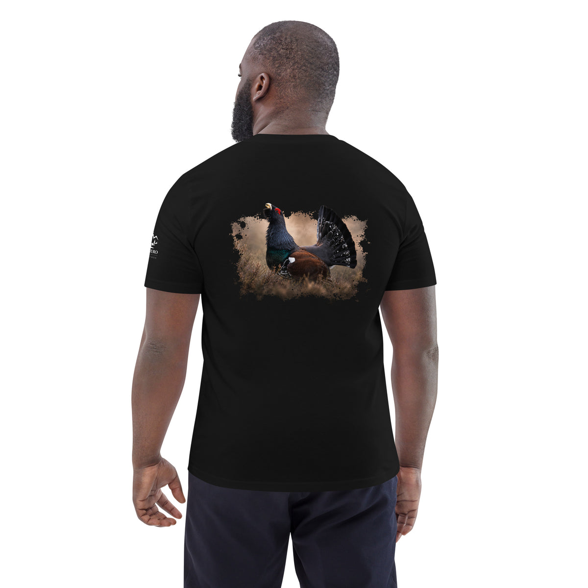 Man wearing a black Novapuro organic eco t-shirt with a Capercaillie wildlife print on the back by Jarno Virtanen. Sustainable Nordic apparel.