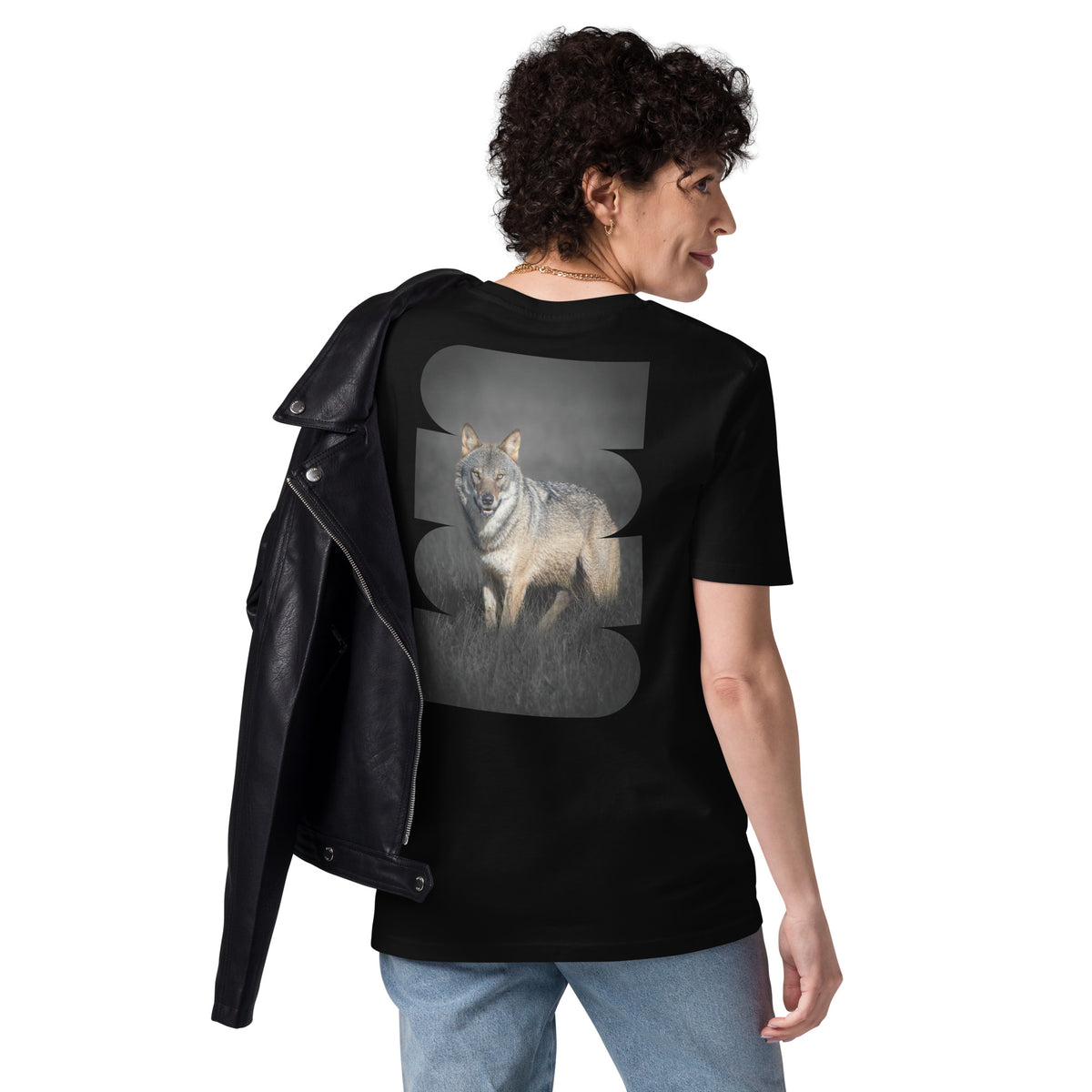 Female model wearing a black unisex organic cotton t-shirt with a striking Dark Alpha Wolf back print. Eco-conscious Scandinavian nature apparel.