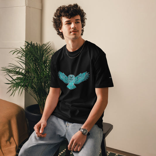 Model wearing the black Novapuro organic cotton t-shirt featuring a striking geometric teal owl print.