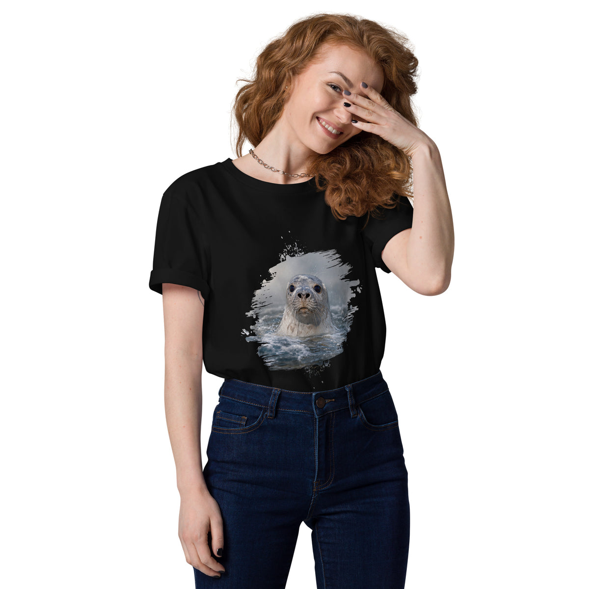 Woman wearing a black Novapuro organic eco t-shirt featuring a captivating Baltic Grey Seal photograph by Jarno Virtanen. Sustainable Nordic streetwear.