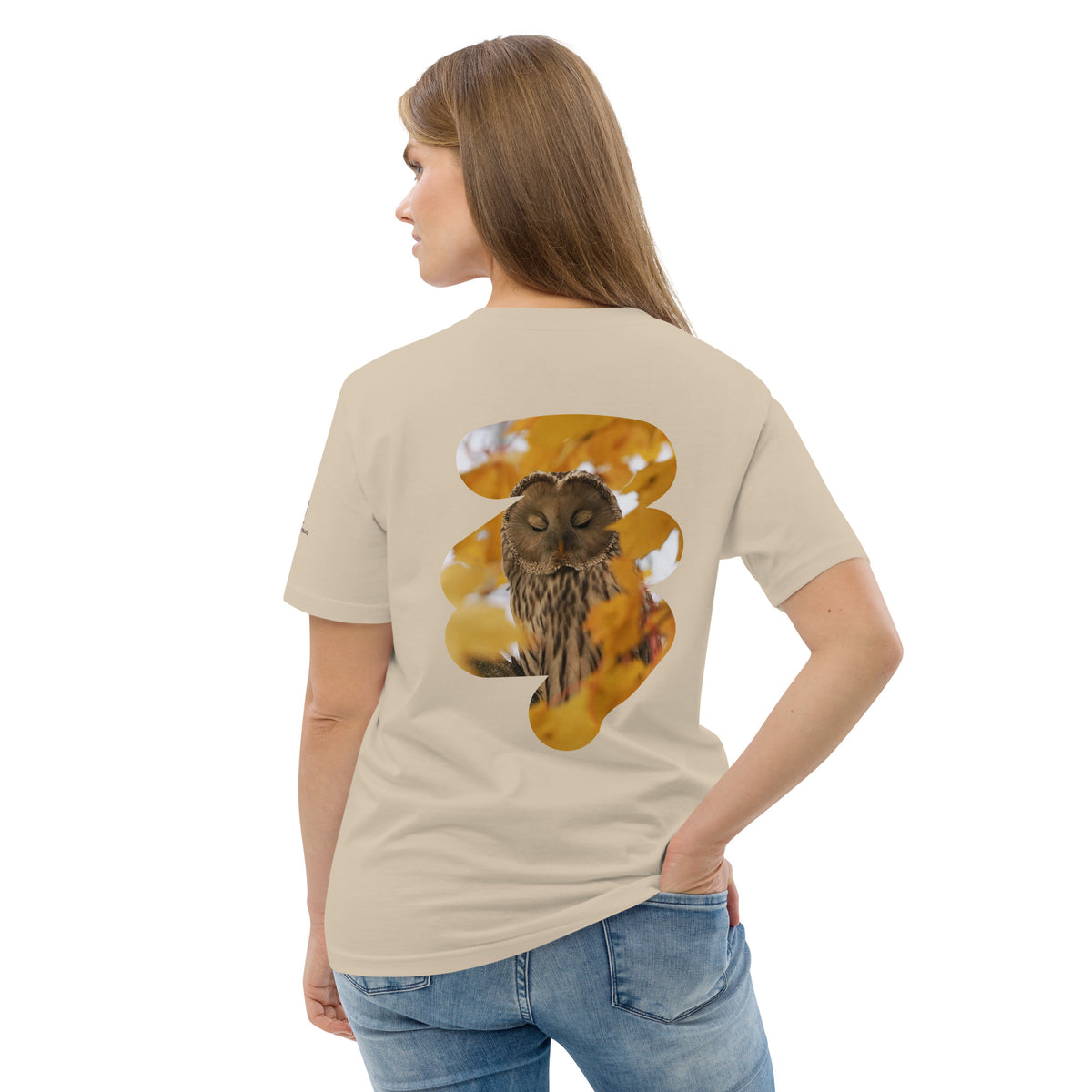 Woman walking in a Nordic forest wearing the Ural Owl Organic T-Shirt, showcasing fine art wild owl photography on sustainable apparel.