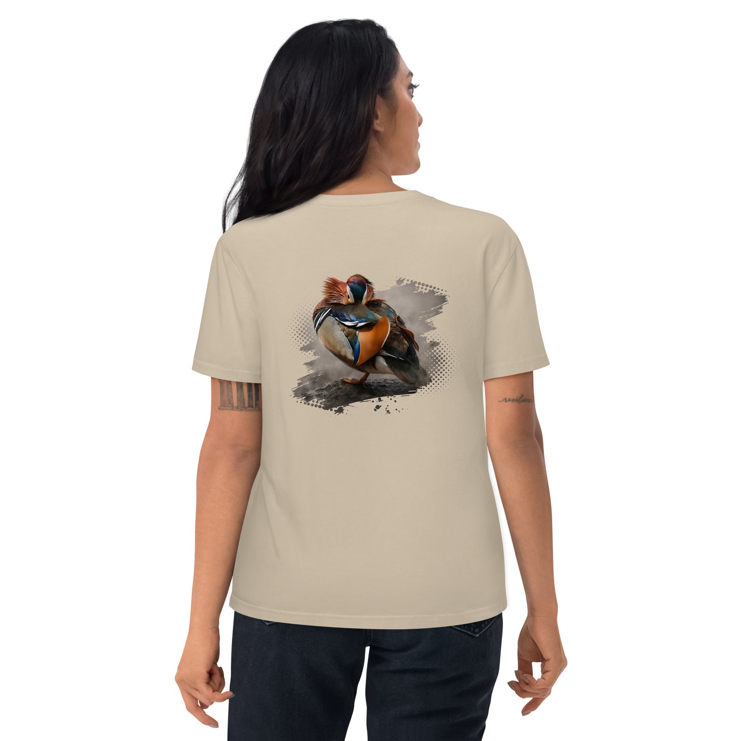 Woman wearing a Desert Dust sand-colored Novapuro x Jarno Virtanen organic cotton t-shirt featuring a colorful Mandarin Duck wildlife artwork on the back, studio shot