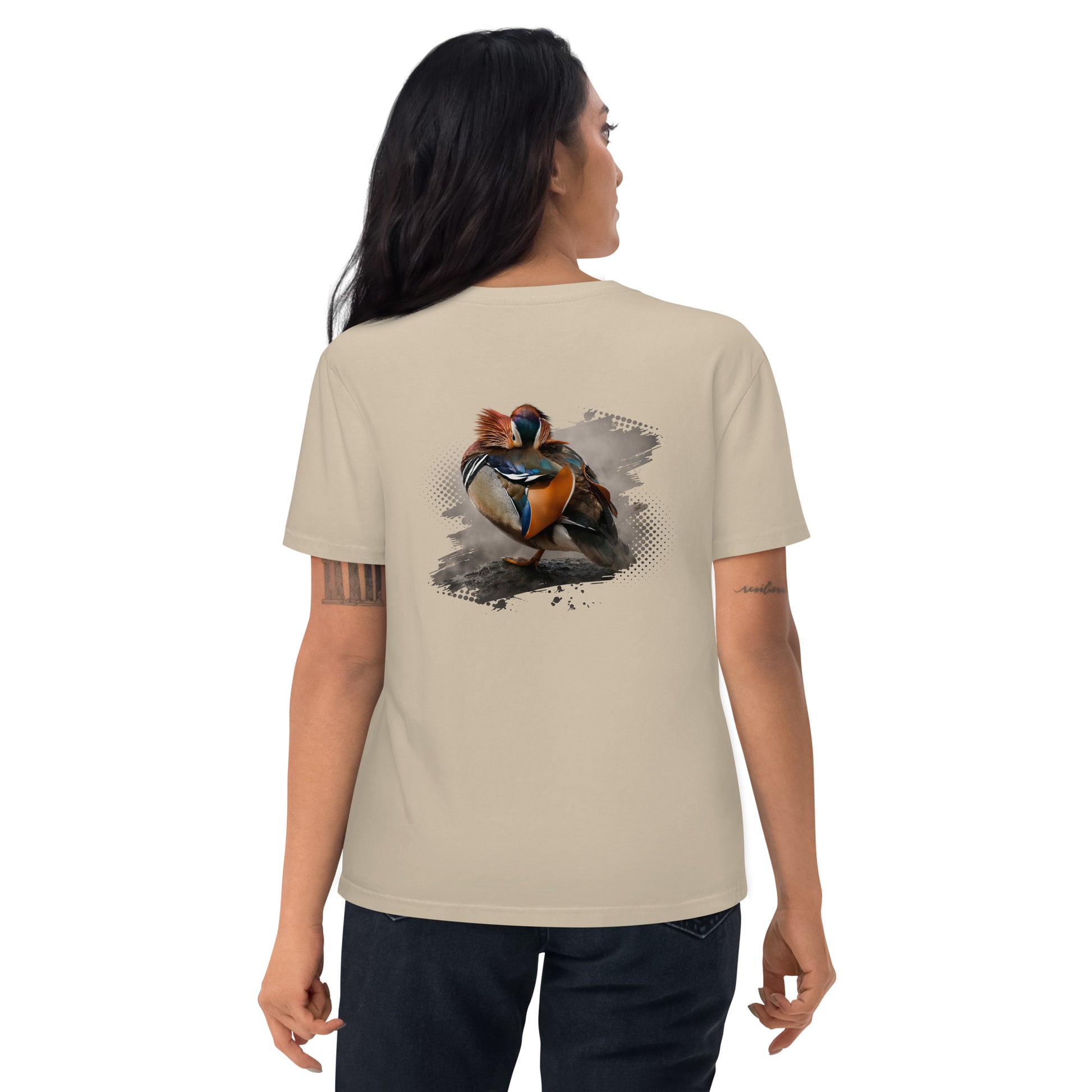 Woman wearing a Desert Dust sand-colored Novapuro x Jarno Virtanen organic cotton t-shirt featuring a colorful Mandarin Duck wildlife artwork on the back, studio shot