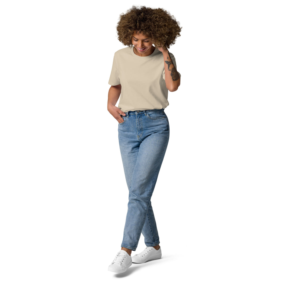 Woman posing in a comfortable beige eco-friendly organic cotton t-shirt. A versatile Scandinavian design ideal for everyday sustainable fashion.