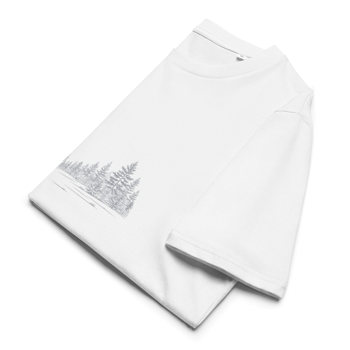 Folded premium organic cotton t-shirt showcasing a serene Scandinavian winter forest design.