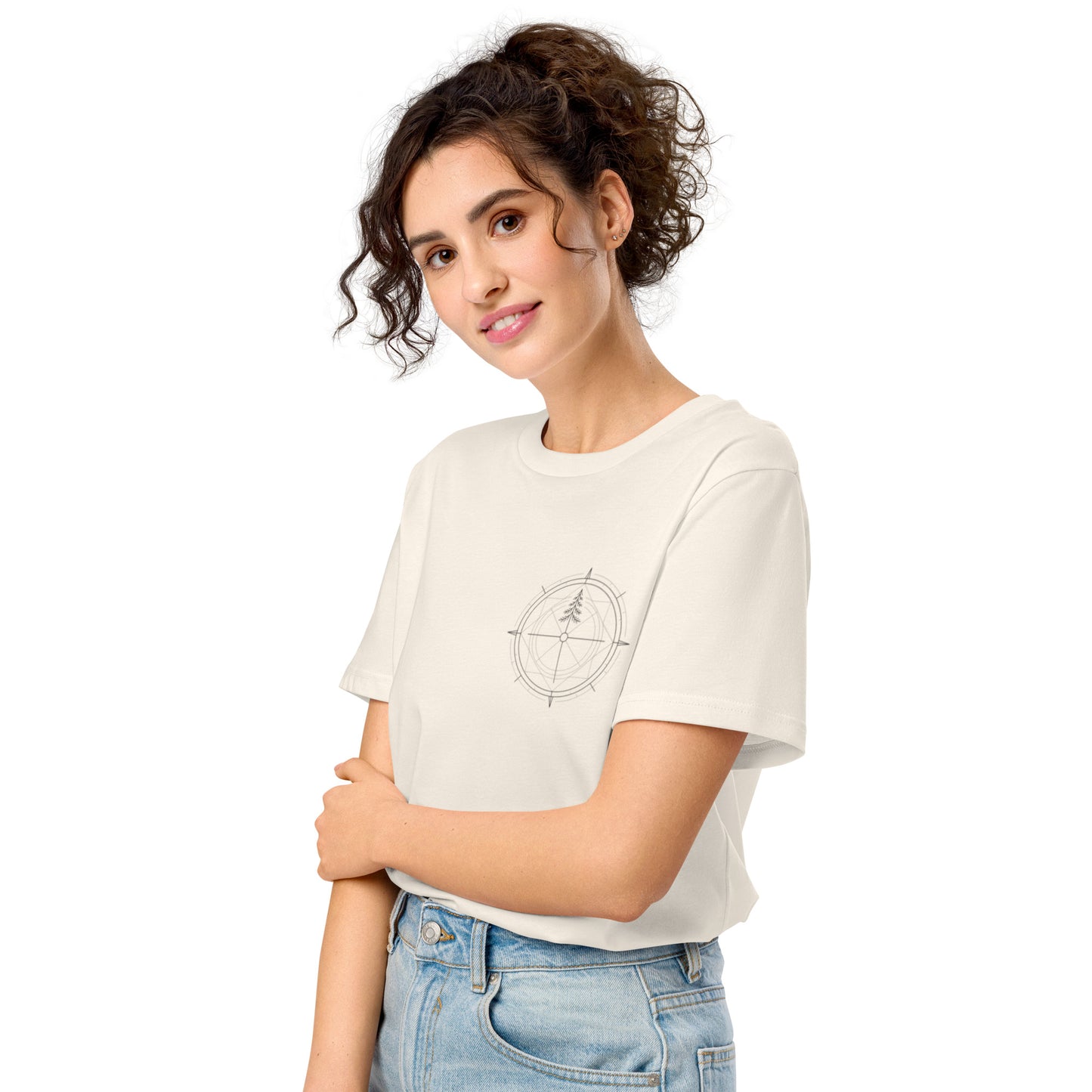 Cream white organic cotton t-shirt worn by a model, featuring a minimalist compass and pine tree design on the left chest.