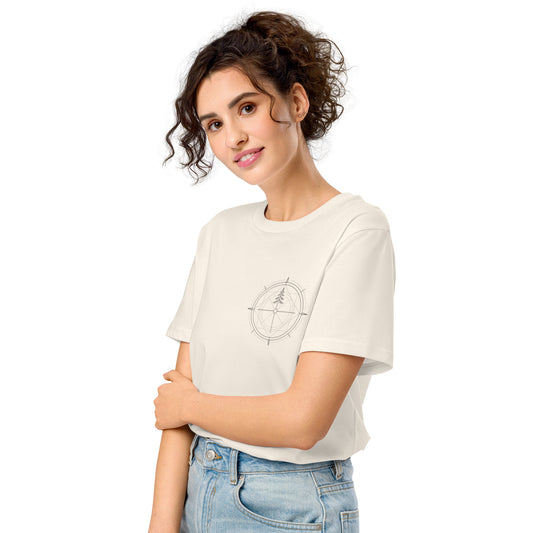 Cream white organic cotton t-shirt worn by a model, featuring a minimalist compass and pine tree design on the left chest.