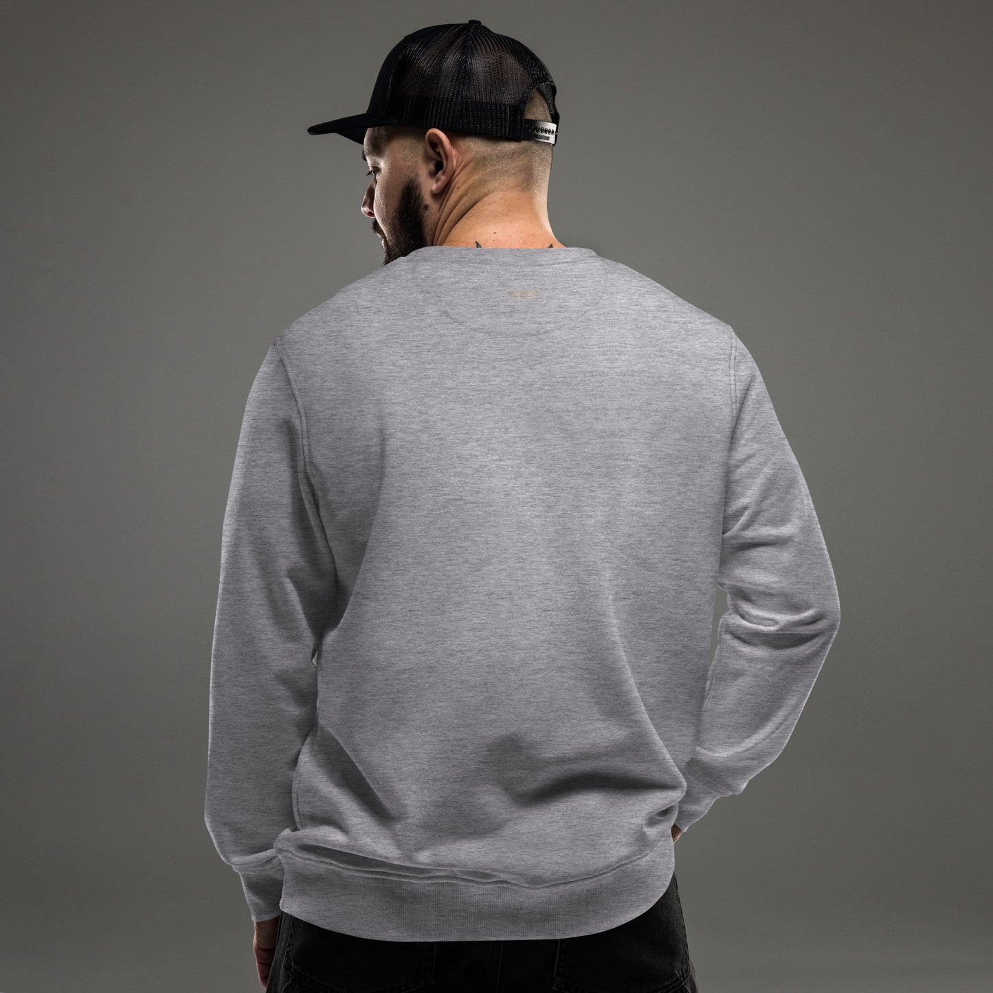 Back view of a man wearing a grey eco-friendly organic sweatshirt, ideal for modern outdoor Nordic style.