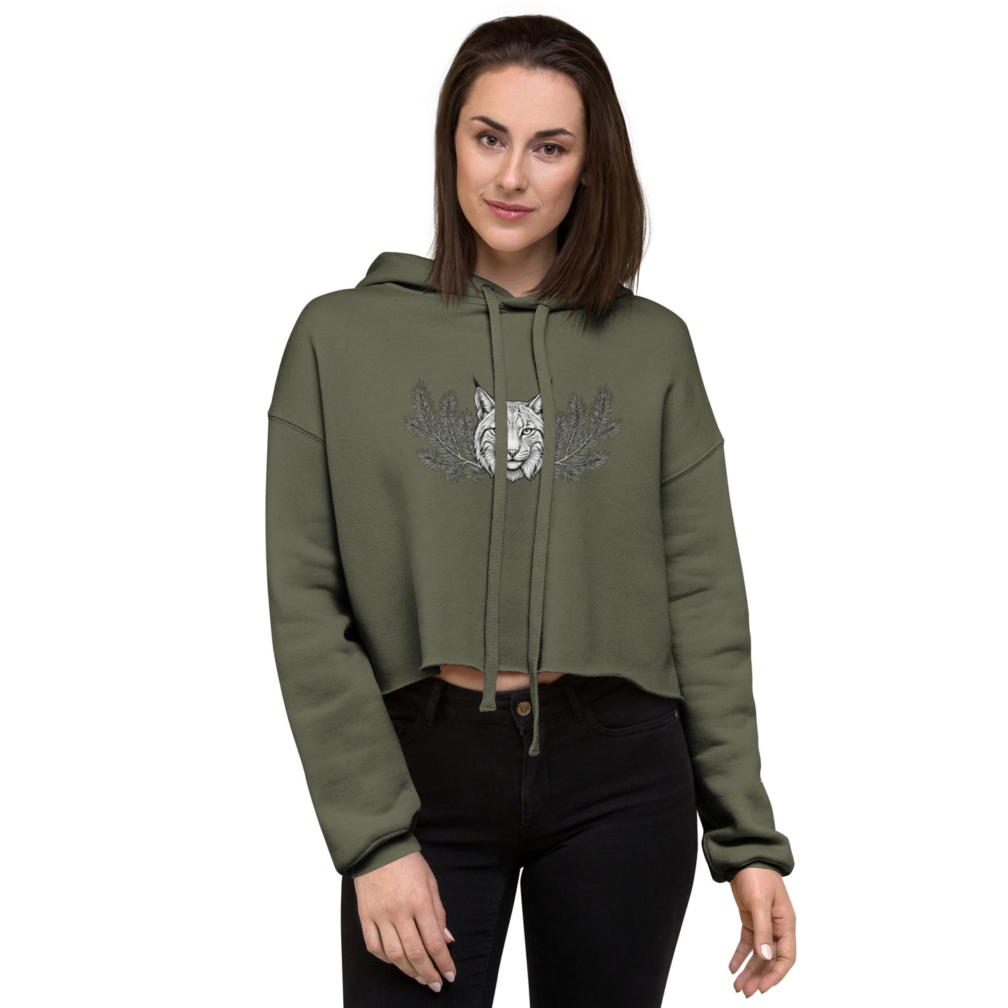 Woman wearing a military green cropped hoodie featuring a mystical Nordic lynx illustration. Trendy raw hem fleece pullover with a detailed black and white forest ghost design.