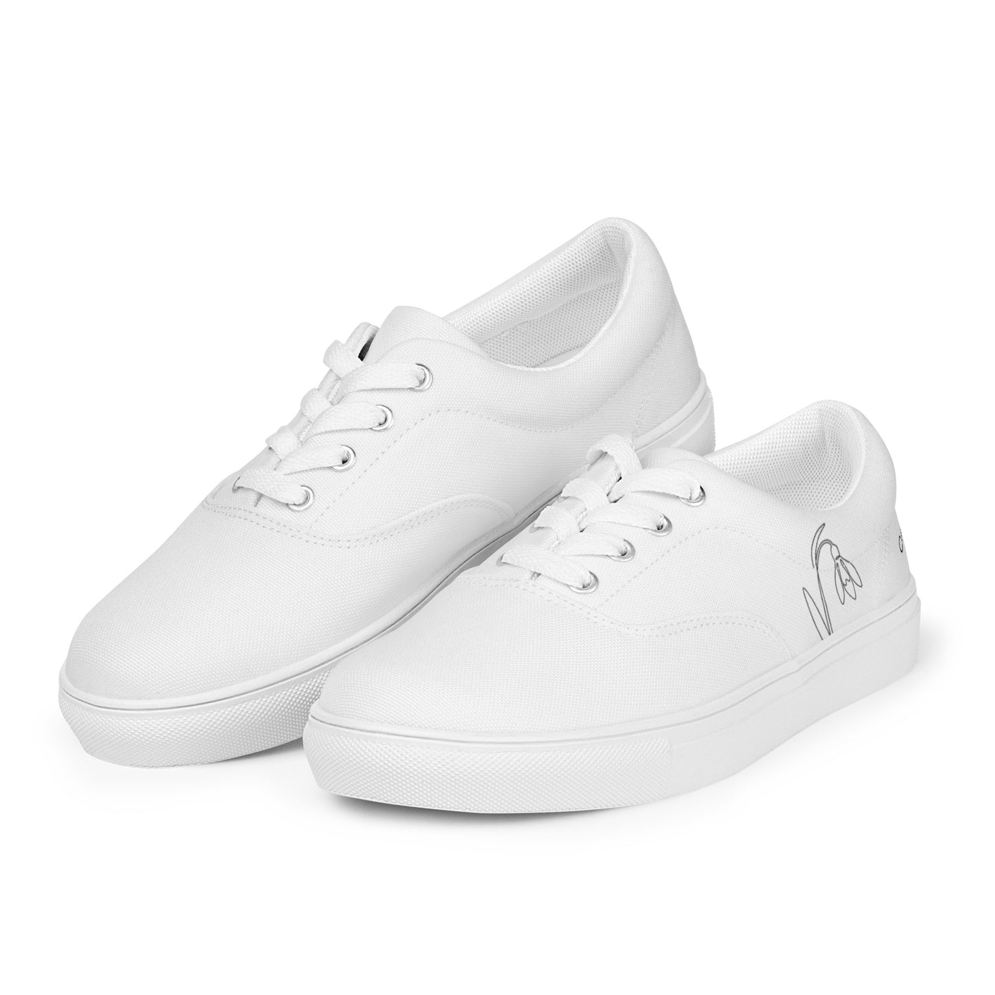 Minimalist white women's canvas sneakers with black First Bloom snowdrop design by Novapuro