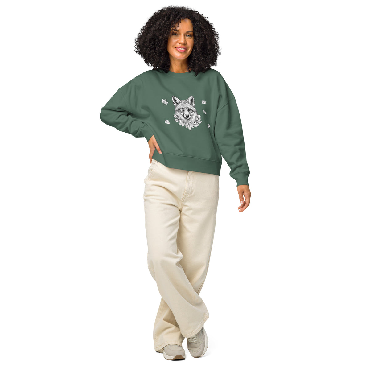Smiling woman modeling the green Nordic Fox women's organic sweatshirt from the Annette Thomé-Marttinen x Novapuro sustainable clothing collection.