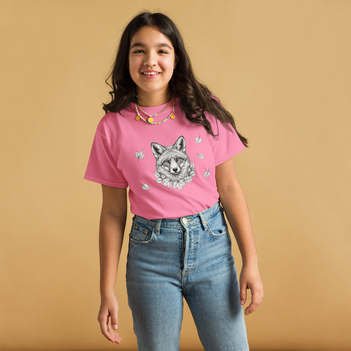 Smiling young girl wearing the sustainable pink Nordic Fox 100% cotton t-shirt from the Annette Thomé-Marttinen x Novapuro kids collection.